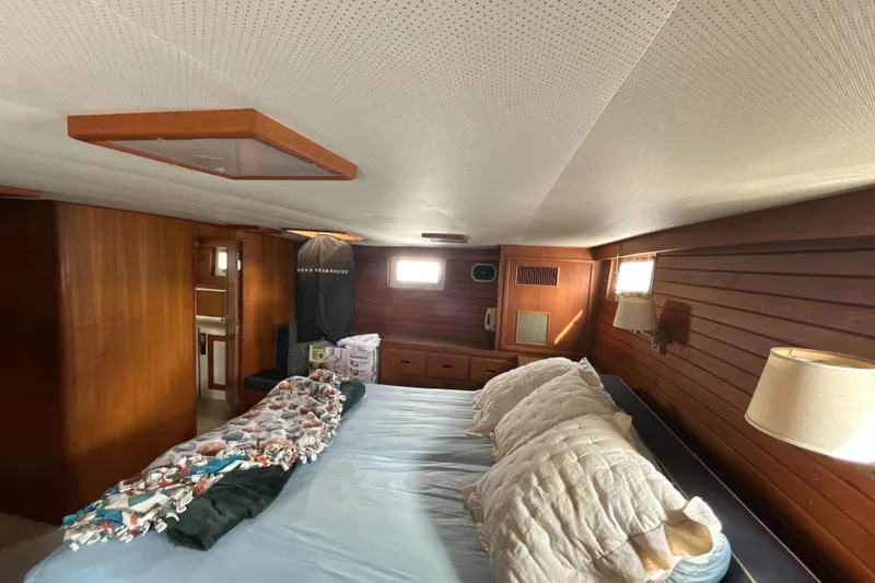 Slide: The Image of Cozy bedroom interior of 1985 Kong & Halvorsen Island Gypsy yacht with wood paneling. - 26