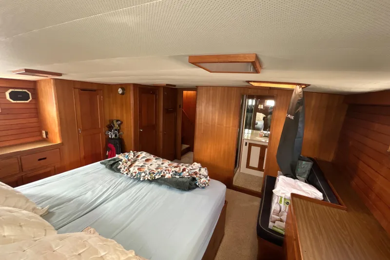 Slide: The Image of 1985 Kong & Halvorsen Island Gypsy yacht interior with wood paneling and cozy bedroom. - 27