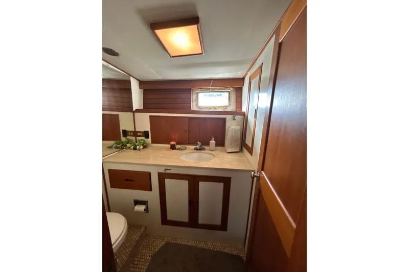 Slide: The Image of 1985 Kong & Halvorsen Island Gypsy yacht bathroom with wooden cabinetry and modern fixtures. - 3