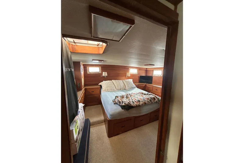 Slide: The Image of Cozy bedroom interior of 1985 Kong & Halvorsen Island Gypsy yacht with wood paneling. - 30