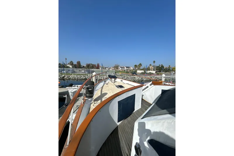 Slide: The Image of 1985 Kong & Halvorsen Island Gypsy yacht deck with wooden railings, docked in marina. - 34