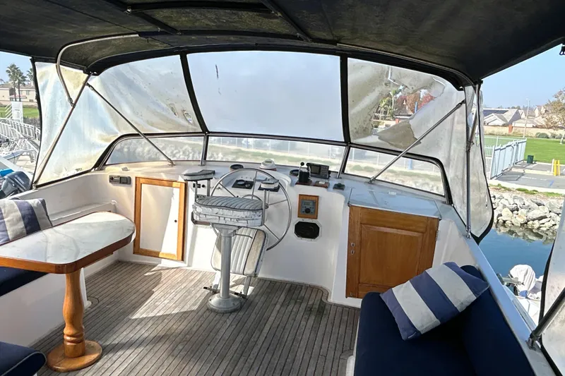 Slide: The Image of 1985 Kong & Halvorsen Island Gypsy boat interior with helm, seating, and table. - 38