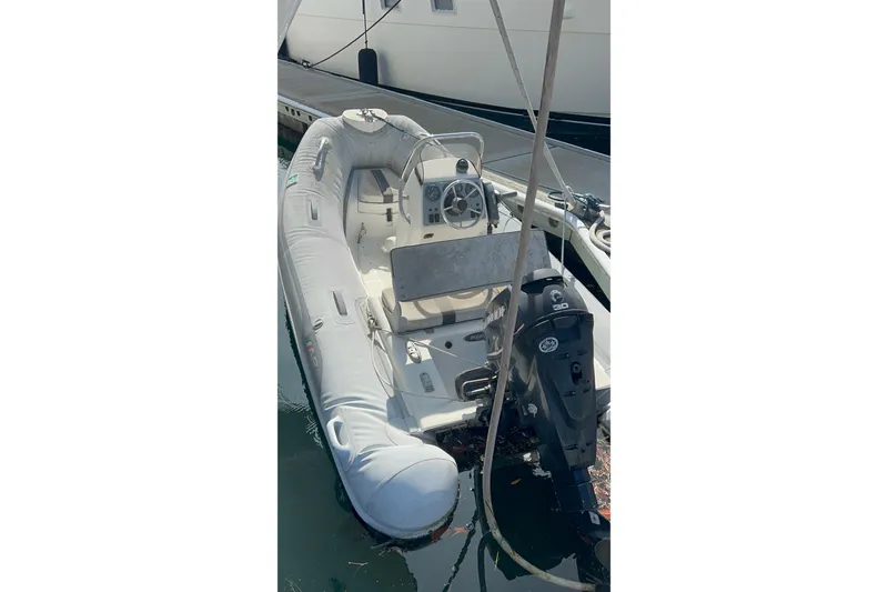 Slide: The Image of Inflatable boat docked, featuring a steering console and outboard motor. Kong & Halvorsen Island Gypsy, 1985. - 41