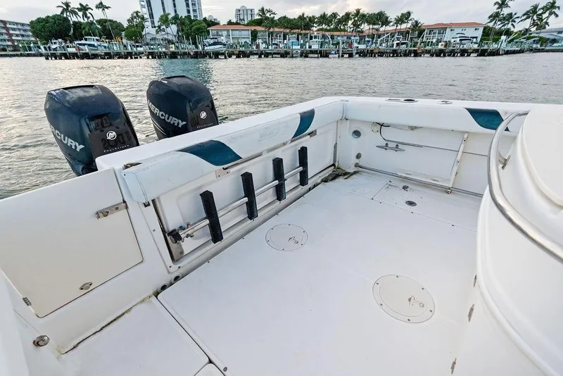 Slide: The Image of 2005 Boston Whaler 320 Outrage Cuddy Cabin boat deck with Mercury engines. - 17