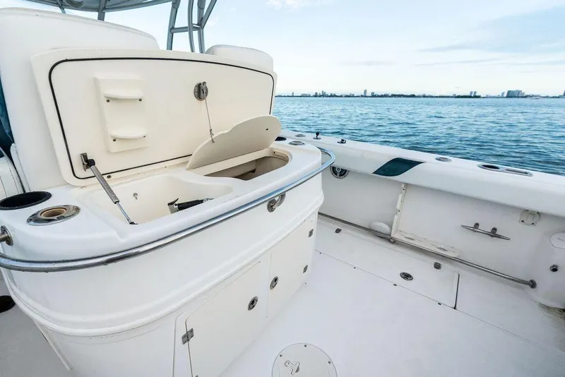 Slide: The Image of 2005 Boston Whaler 320 Outrage Cuddy Cabin interior with open storage, ocean view. - 20
