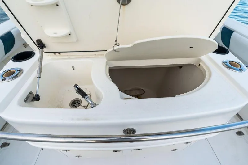 Slide: The Image of 2005 Boston Whaler 320 Outrage Cuddy Cabin sink and storage compartment on deck. - 21