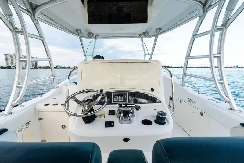 Slide: The Image of 2005 Boston Whaler 320 Outrage Cuddy Cabin helm with ocean view. - 22