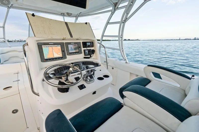 Slide: The Image of 2005 Boston Whaler 320 Outrage Cuddy Cabin helm with navigation equipment and ocean view. - 23