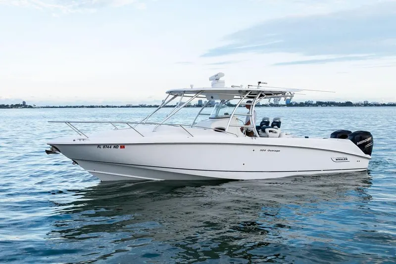 Slide: The Image of 2005 Boston Whaler 320 Outrage Cuddy Cabin on calm water, side view. - 3
