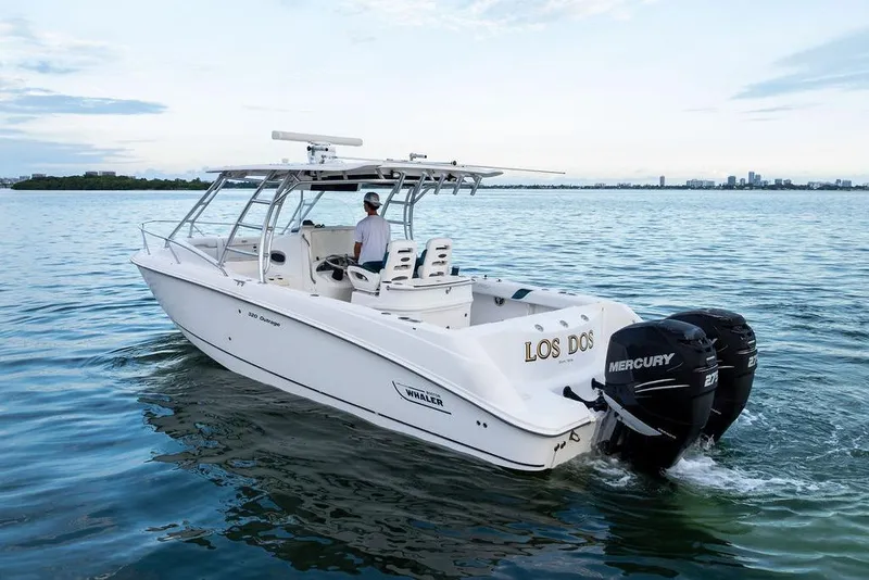 Slide: The Image of 2005 Boston Whaler 320 Outrage Cuddy Cabin cruising on calm waters. - 4