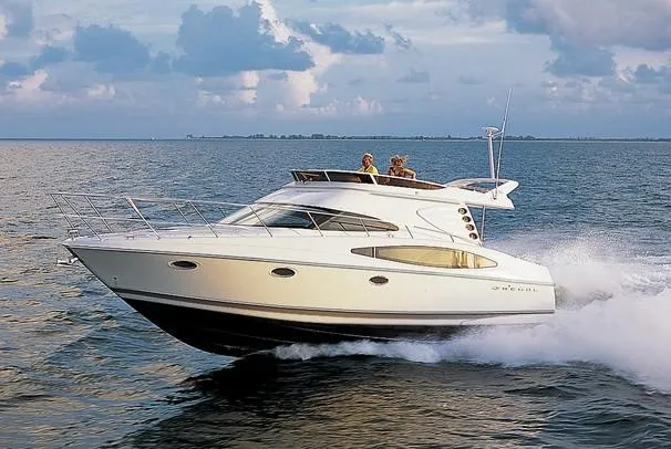 Slide: The Image of 2003 Regal Commodore 3880 yacht docked in marina, featuring sleek design and spacious deck. - 1