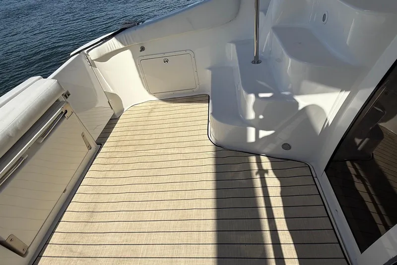 Slide: The Image of 2003 Regal Commodore 3880 boat deck with striped flooring and white interior. - 10