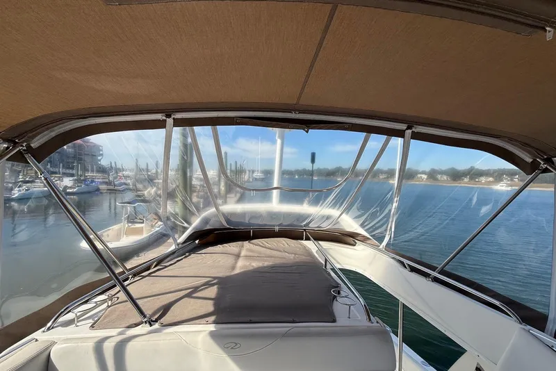 Slide: The Image of 2003 Regal Commodore 3880 yacht interior with marina view through clear canopy. - 22