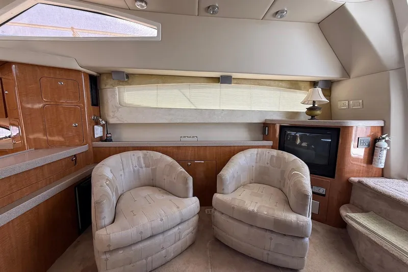 Slide: The Image of Interior of 2003 Regal Commodore 3880 yacht with cozy seating and elegant wood finishes. - 24
