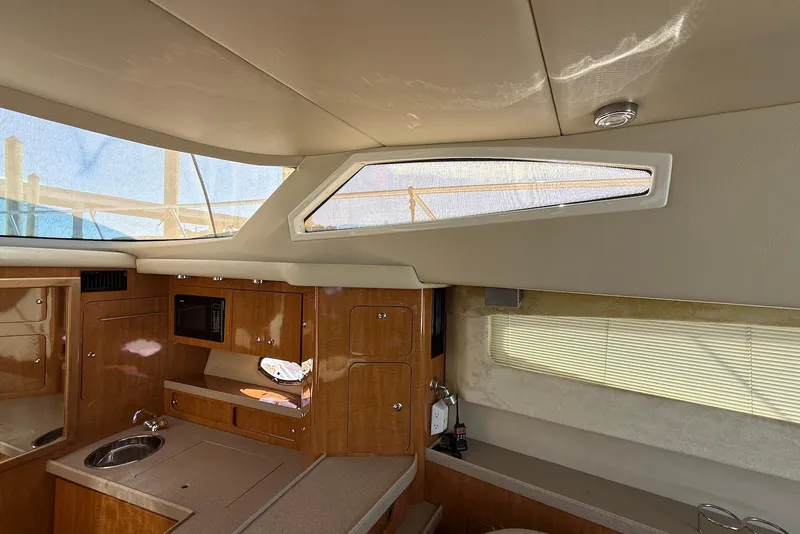 Slide: The Image of Interior of 2003 Regal Commodore 3880 yacht with wooden cabinetry and modern amenities. - 26