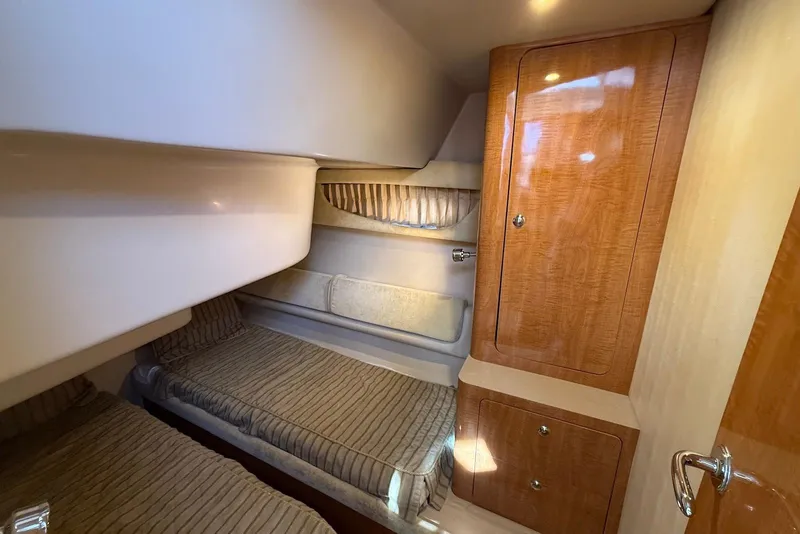 Slide: The Image of 2003 Regal Commodore 3880 cabin interior with twin beds and wooden cabinetry. - 34