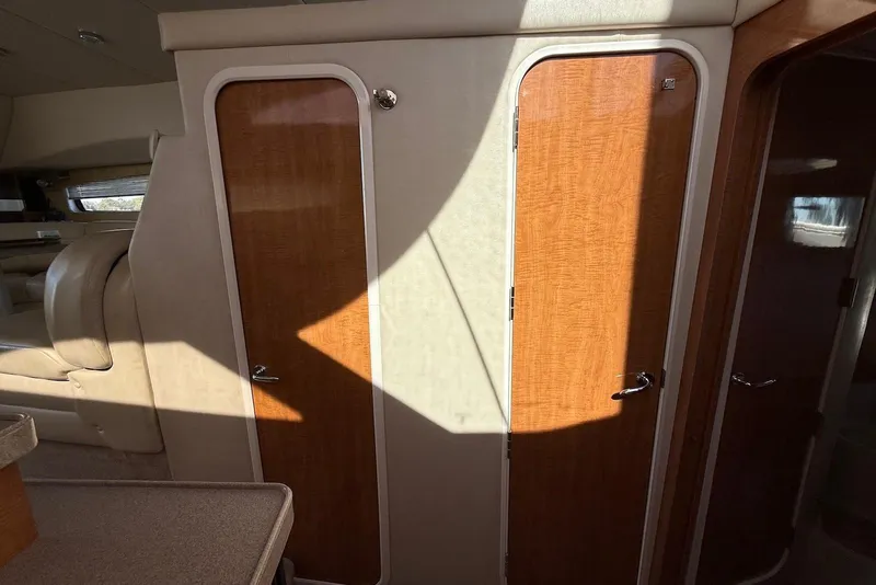 Slide: The Image of Interior of 2003 Regal Commodore 3880 yacht with wooden doors and beige seating. - 36