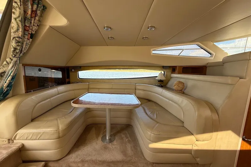 Slide: The Image of Luxurious interior of 2003 Regal Commodore 3880 yacht with plush seating and elegant table. - 37