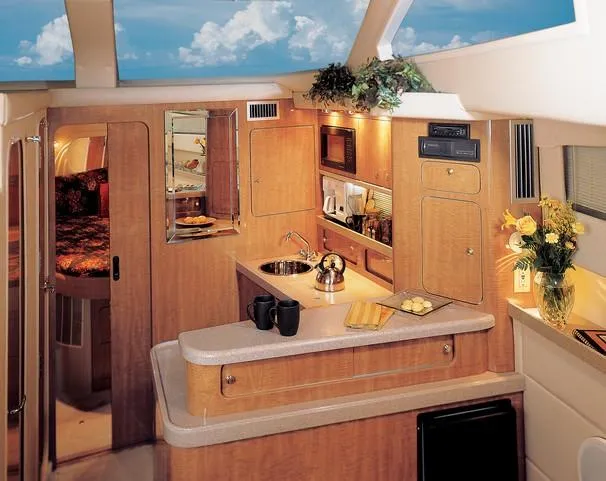 Slide: The Image of 2003 Regal Commodore 3880 yacht docked by a bridge on a sunny day. - 4