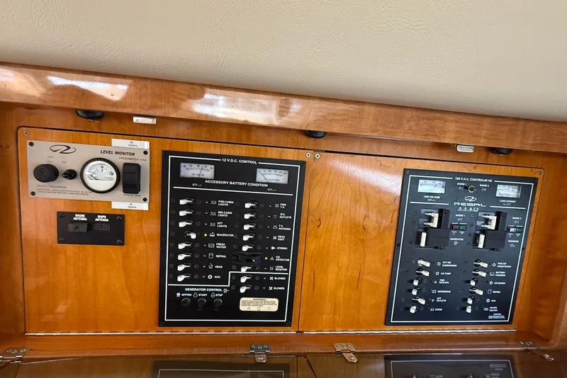 Slide: The Image of Control panel of a 2003 Regal Commodore 3880 boat, featuring various switches and gauges. - 41