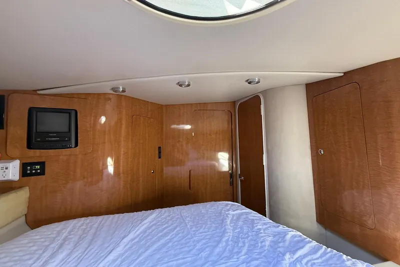 Slide: The Image of 2003 Regal Commodore 3880 cabin interior with wood paneling and a small TV. - 42