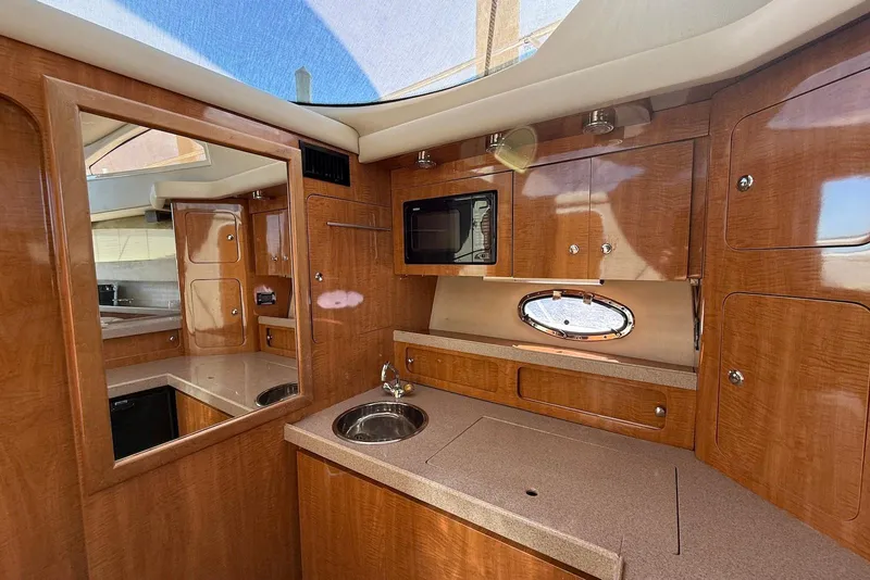 Slide: The Image of Luxurious 2003 Regal Commodore 3880 yacht interior with wood cabinetry and modern amenities. - 43