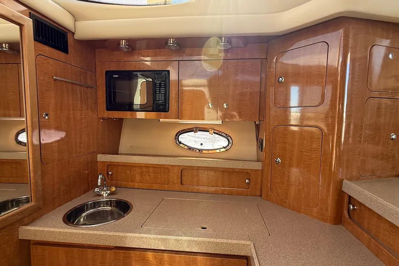 Slide: The Image of Luxurious 2003 Regal Commodore 3880 yacht kitchen with wood cabinetry and modern amenities. - 44