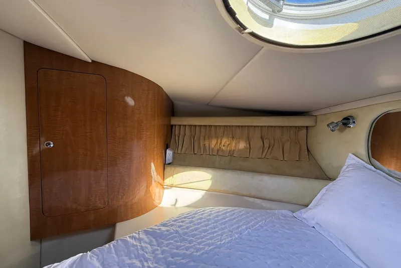 Slide: The Image of 2003 Regal Commodore 3880 cabin interior with wood paneling and cozy bedding. - 46