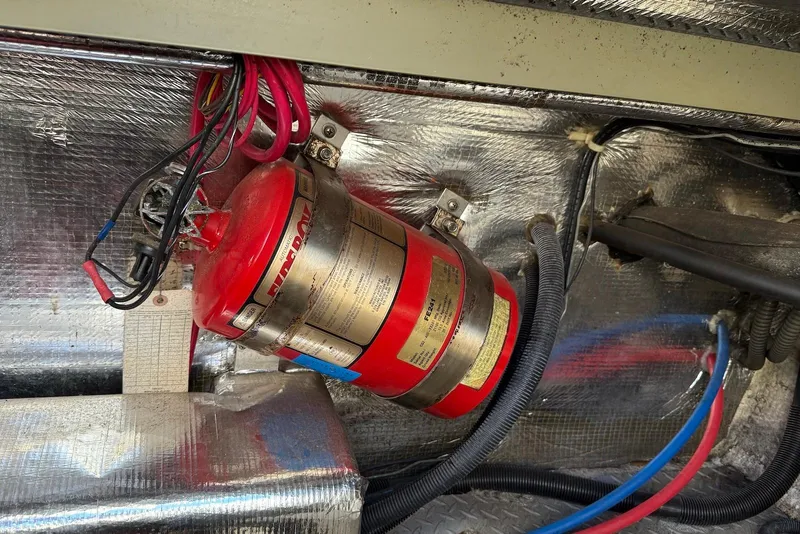 Slide: The Image of Engine compartment of 2003 Regal Commodore 3880 with mounted fire extinguisher and wiring. - 50