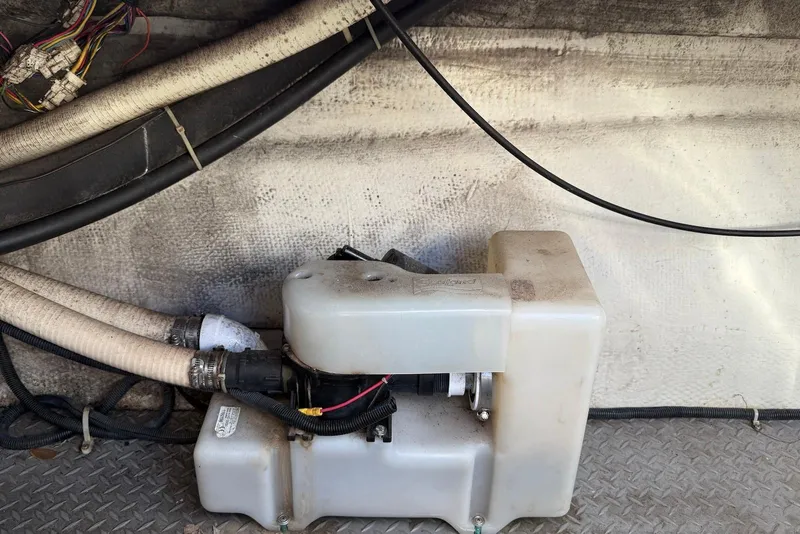 Slide: The Image of Bilge pump system in a 2003 Regal Commodore 3880 boat, with connected hoses and wiring. - 54