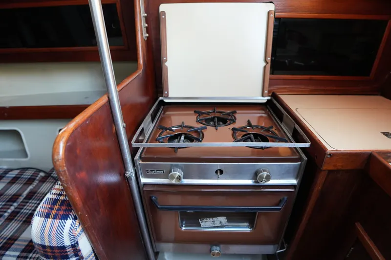 Slide: The Image of Vintage 1978 C&C 34 yacht interior with a classic two-burner stove. - 16