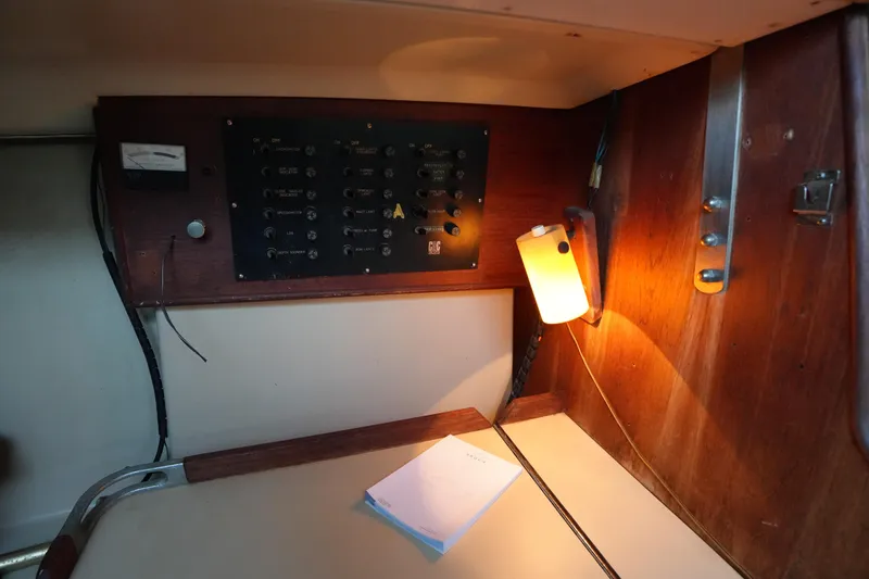Slide: The Image of 1978 C&C 34 sailboat interior with control panel and warm lighting. - 18