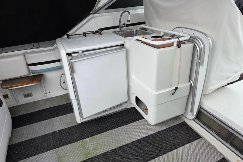 Slide: The Image of 1990 Trojan 10 Meter Express 330 boat interior with kitchenette and sink. - 10