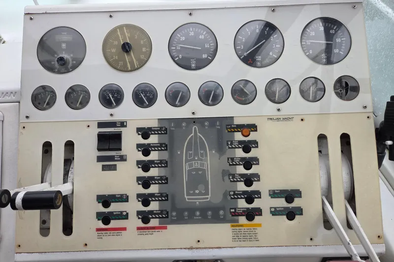 Slide: The Image of Control panel of a 1990 Trojan 10 Meter Express 330 yacht with gauges and switches. - 13