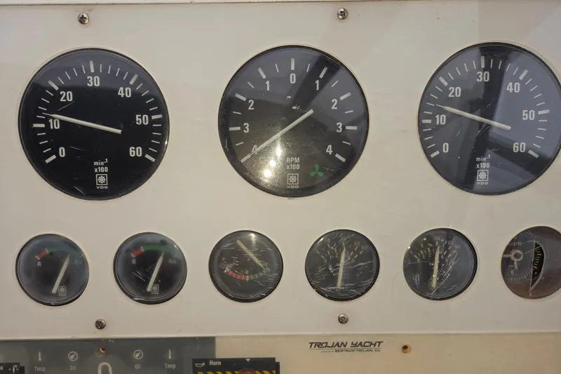 Slide: The Image of Dashboard of a 1990 Trojan 10 Meter Express 330 yacht with various gauges. - 14