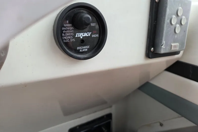 Slide: The Image of Fireboy discharge alarm on 1990 Trojan 10 Meter Express 330 boat dashboard. - 17