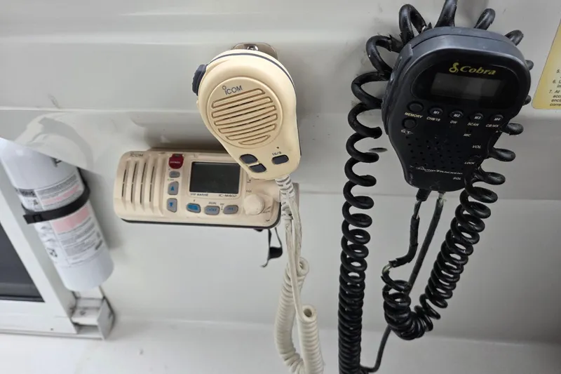 Slide: The Image of Marine radio equipment on a 1990 Trojan 10 Meter Express 330 boat dashboard. - 18