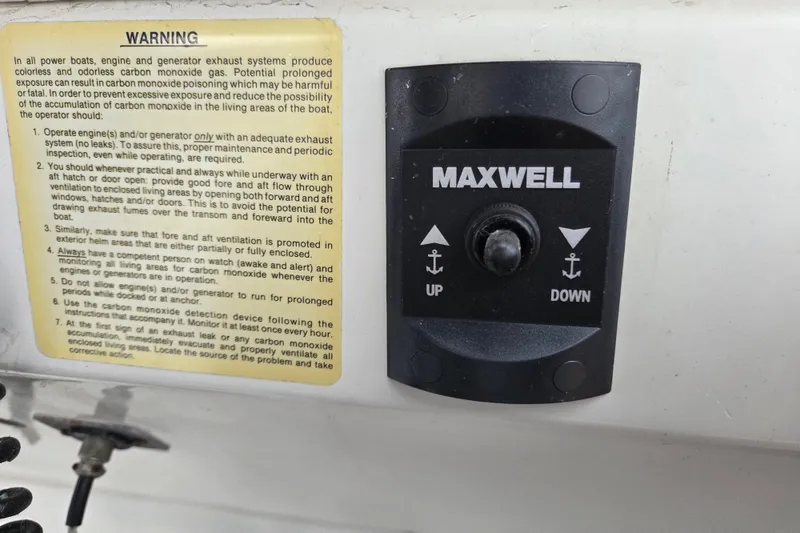 Slide: The Image of Trojan 10 Meter Express 330, 1990 model, Maxwell anchor control panel with safety warning. - 19