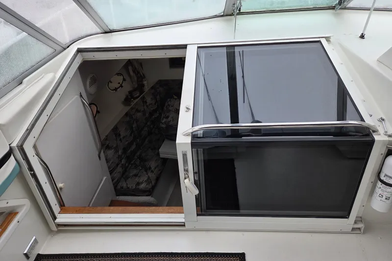 Slide: The Image of 1990 Trojan 10 Meter Express 330 cabin entrance with sliding door and interior seating. - 20