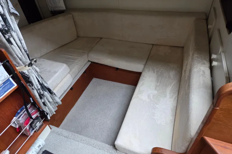 Slide: The Image of Interior of a 1990 Trojan 10 Meter Express 330 with beige seating and wooden accents. - 25