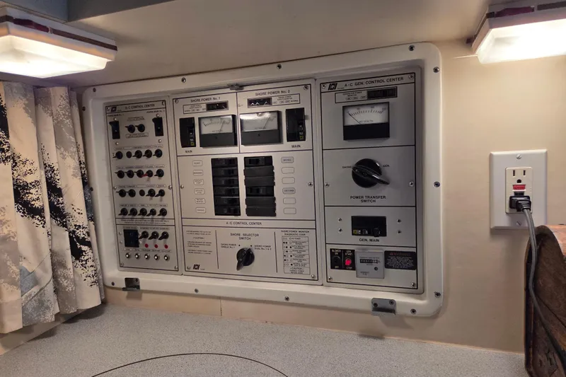 Slide: The Image of Control panel of a 1990 Trojan 10 Meter Express 330 boat, featuring switches and meters. - 32