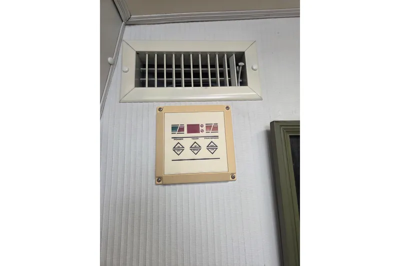 Slide: The Image of Control panel and vent on a 1990 Trojan 10 Meter Express 330 boat interior. - 33