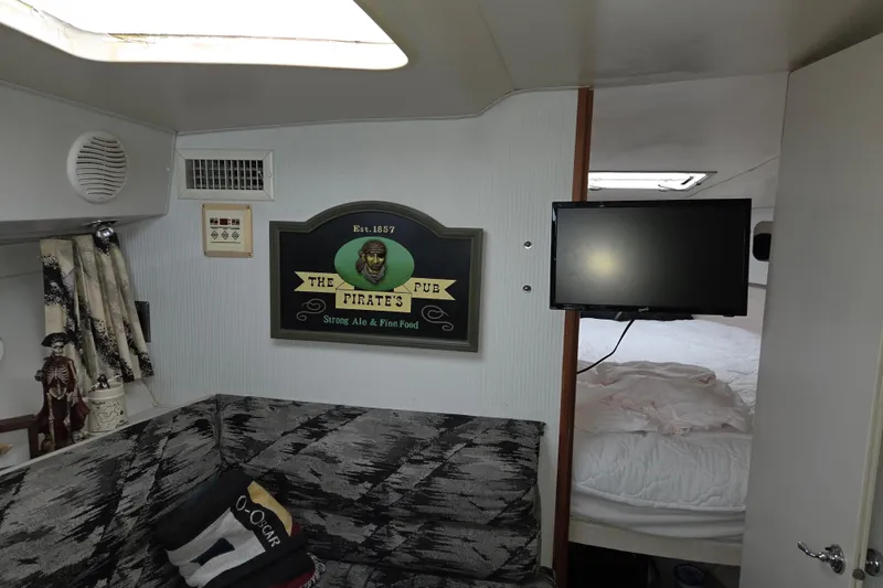 Slide: The Image of Interior of 1990 Trojan 10 Meter Express 330 with pirate-themed decor and TV. - 34