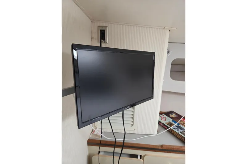 Slide: The Image of Flat-screen TV mounted inside a 1990 Trojan 10 Meter Express 330 boat cabin. - 35
