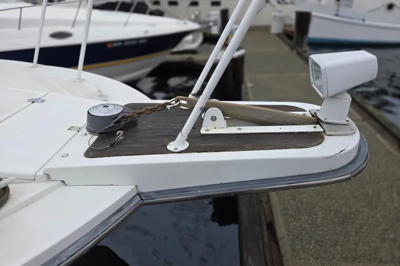 Slide: The Image of Bow of 1990 Trojan 10 Meter Express 330 with anchor and spotlight at dock. - 4