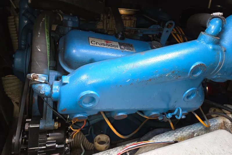 Slide: The Image of Engine of a 1990 Trojan 10 Meter Express 330 boat, featuring a blue Crusader motor. - 40