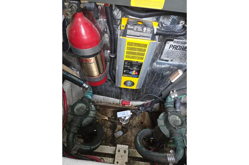 Slide: The Image of Engine compartment of a 1990 Trojan 10 Meter Express 330 with fire extinguisher and battery charger. - 41