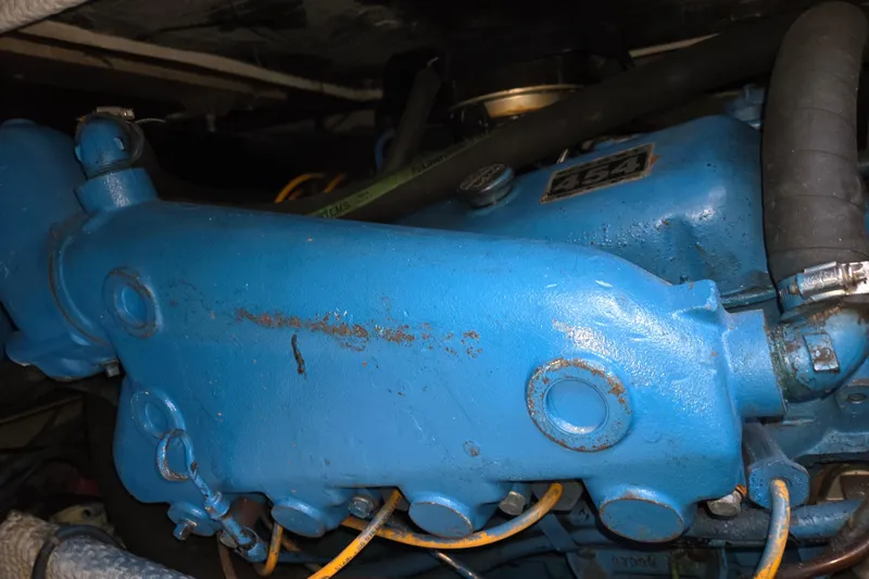 Slide: The Image of Engine component of a 1990 Trojan 10 Meter Express 330, painted blue with visible hoses. - 43