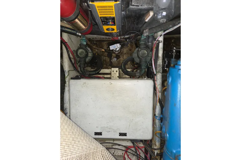 Slide: The Image of Engine compartment of a 1990 Trojan 10 Meter Express 330 boat, showing mechanical components. - 44