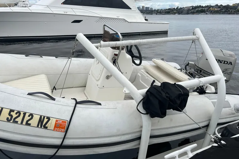 Slide: The Image of 1990 Trojan 10 Meter Express 330 docked with inflatable boat and Honda engine. - 5